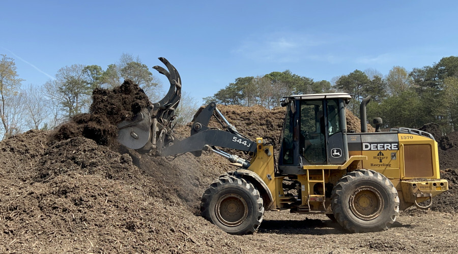 equipment scooping mulch 900x500